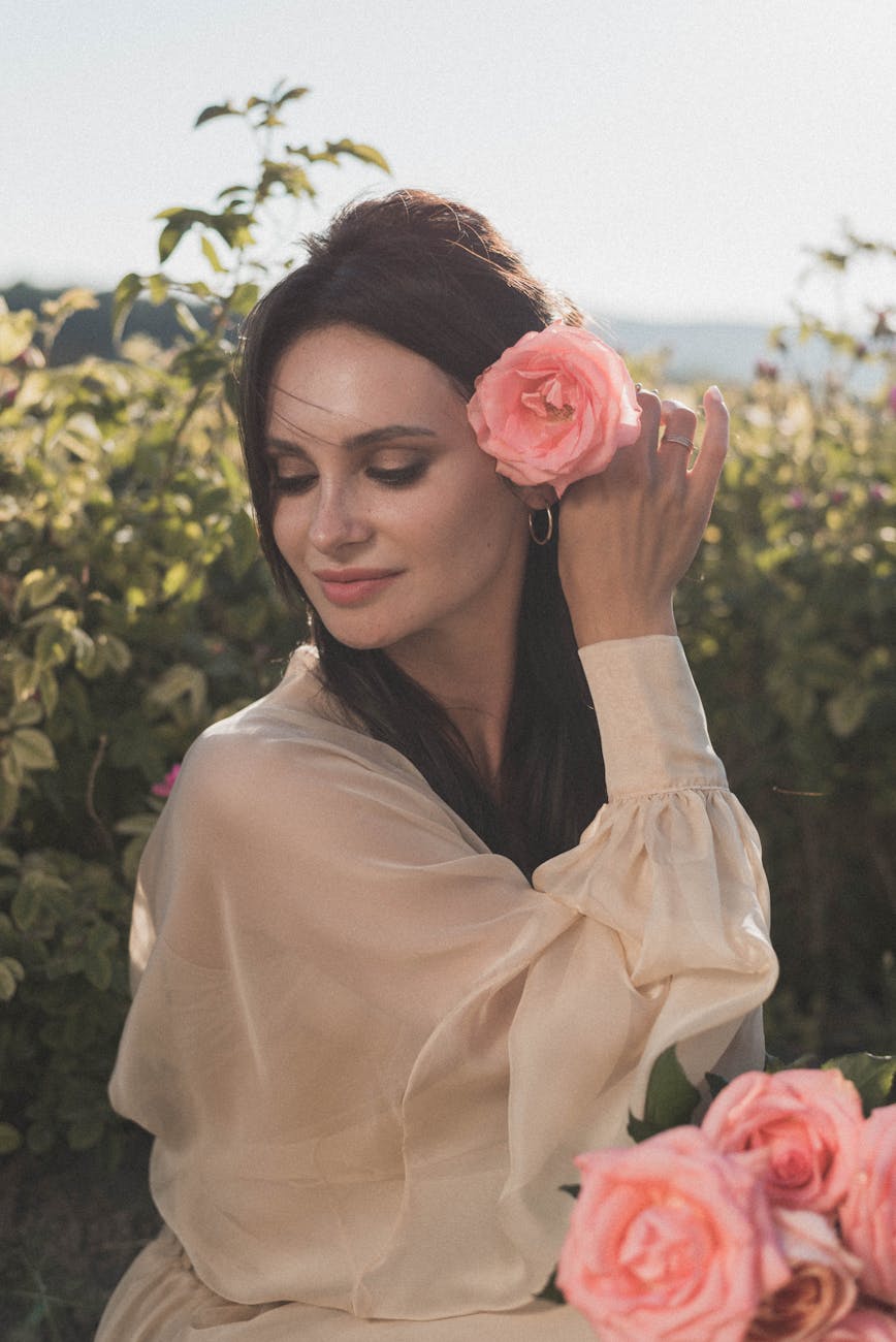 A person sitting in a meditative yoga pose in a tranquil garden setting with soft lighting.